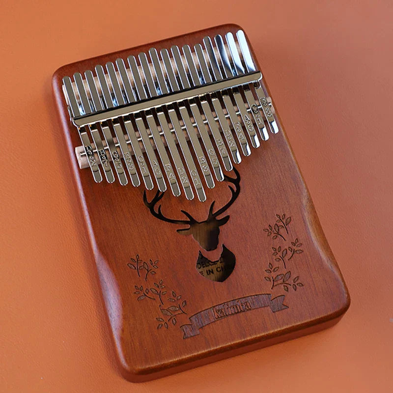 A mahogany wood kalimba music instrument with 17 silver-colored metal tines and a carved deer head design for kids portable mbira finger piano combinations