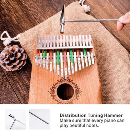 Silver-tipped tuning hammer with textured metal handle for precise calibration of kalimba music instrument keys