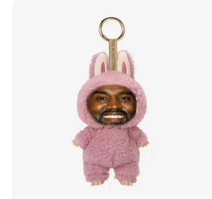 Pink fuzzy bunny onesie keychain with smiling face featuring trendy pendant design for layeye design birthday present trending toy