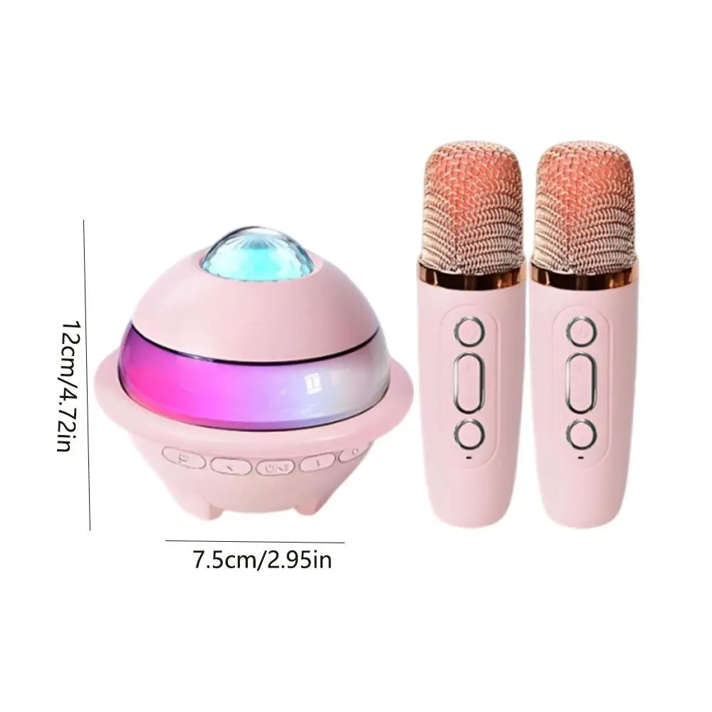 Pink karaoke machine mini with spherical projector night light and wireless dual microphones featuring gold accents