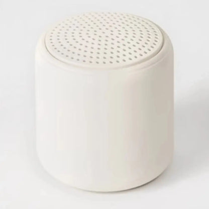 Cream-colored cylindrical karaoke mini bluetooth speaker with perforated top for rechargeable music wireless use