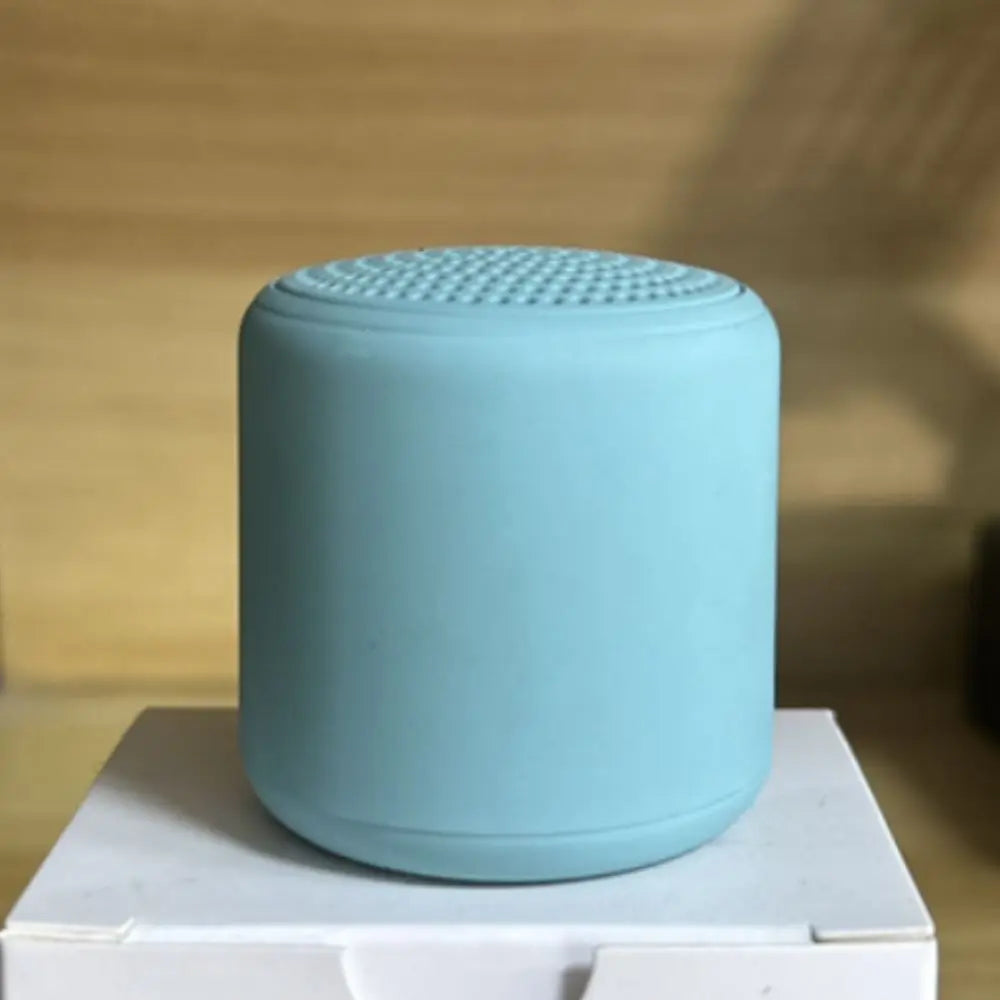 A sleek light blue karaoke mini bluetooth speaker with textured grille for rechargeable music wireless and speaker game hifi