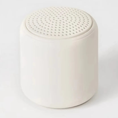 Cream-colored cylindrical karaoke mini bluetooth speaker with perforated top for rechargeable music wireless use