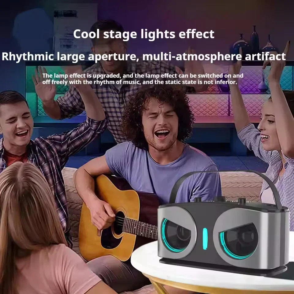 Silver and black karaoke portable wireless speaker with glowing blue circular speaker grilles and microphone machine subwoofer