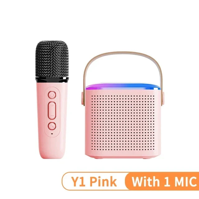Pink karaoke wireless portable bluetooth speaker with handle and colorful led lights paired with matching microphone machine mini