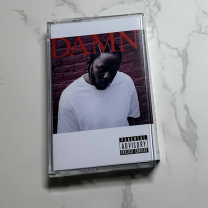 Clear plastic hip hop rap cassette tape featuring kendrick lamar damn album cover with red lettering and black and white photo
