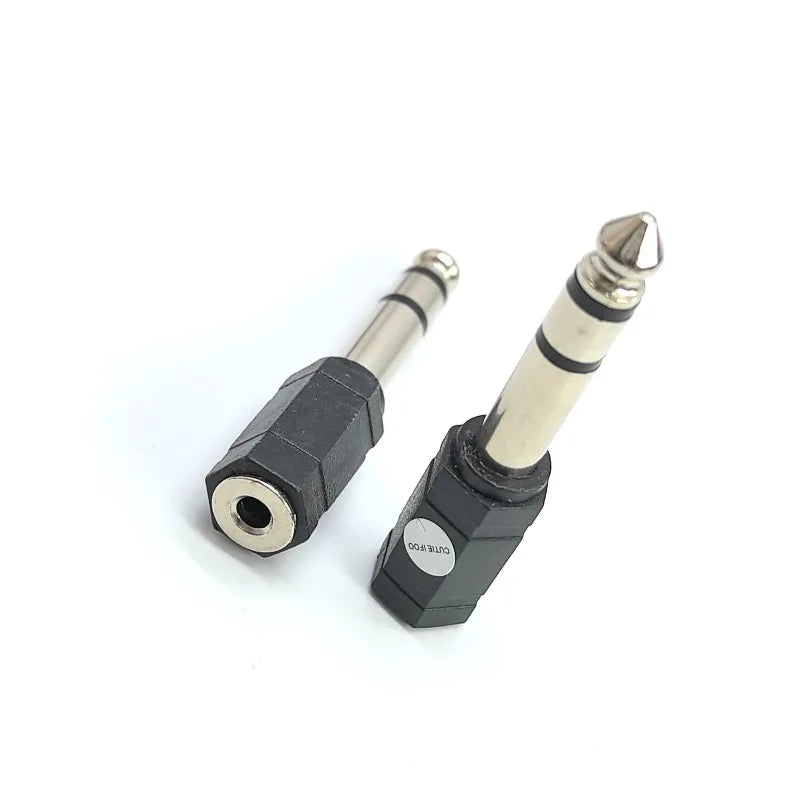 Black plastic electronic drum adapter converter with metallic 6.35mm male plug and female headphone connector jack
