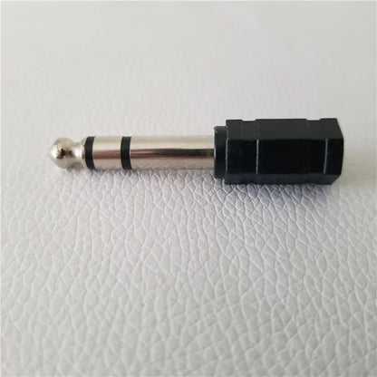 Black plastic-to-metal electronic drum adapter converter with silver 3.5mm jack and rubberized drum plug headphone connector jack