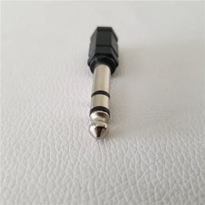 Black and silver 6.35mm electronic drum adapter converter with hexagonal plastic housing and metallic headphone connector jack