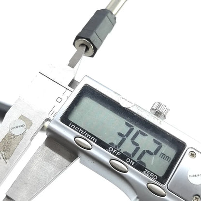 Silver digital caliper measuring 7.52 mm on black metallic drum plug headphone used as electronic drum adapter converter jack