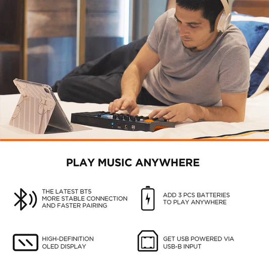 Black and orange portable keyboard midi controller with backlit beat pads and high-definition oled display for cubasis le software