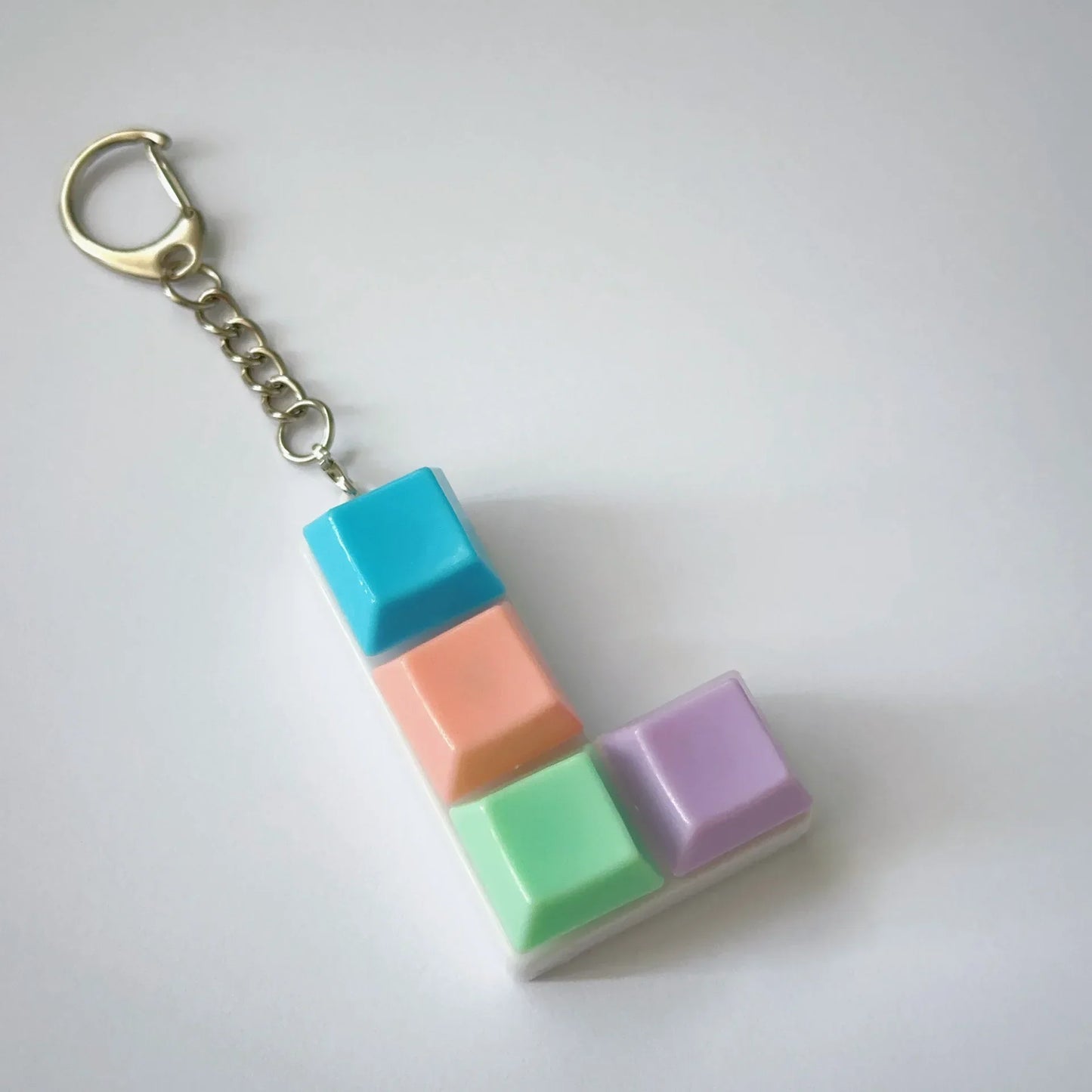 Pastel-colored keychaintoy press stress relief fidget button keycap keychain toy in turquoise peach mint and lavender plastic segments