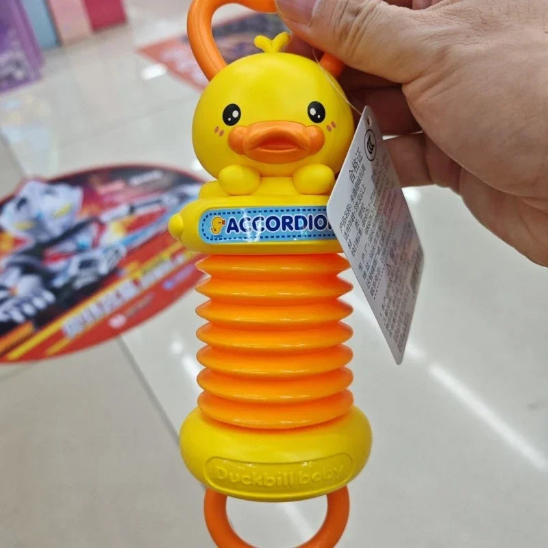 Yellow duck-shaped kids accordion toy with orange accordion body and blue label for educational brain development and travel birthday gift