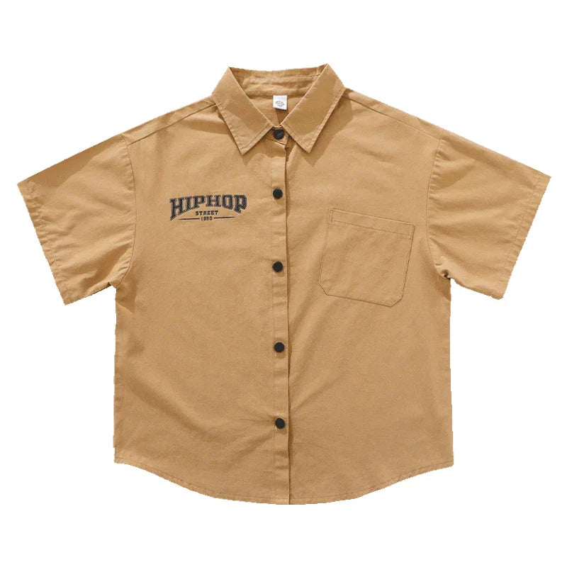 Tan short-sleeved button-up shirt with black hiphop start 1982 embroidery and breast pocket for kids hiphop dance y2k streetwear style