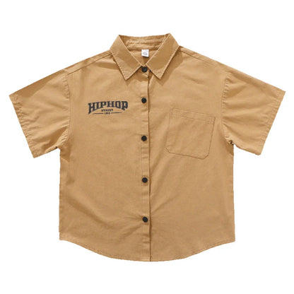Tan short-sleeved button-up shirt with black hiphop start 1982 embroidery and breast pocket for kids hiphop dance y2k streetwear style