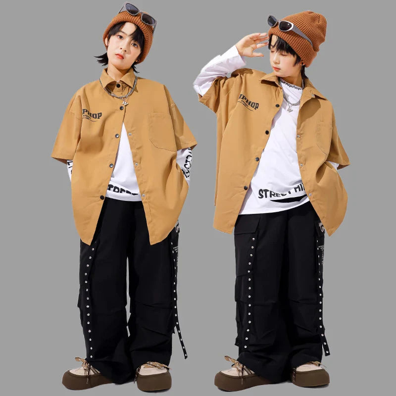 Tan kids hiphop dance short-sleeved button-up shirt with black lettering and side pockets in style y2k streetwear accessories