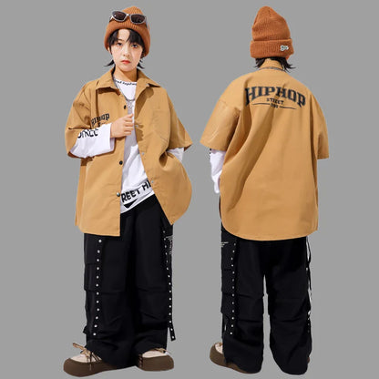 Tan oversized hip-hop streetwear shirt with black lettering and white inner sleeves for kids hiphop dance y2k streetwear style