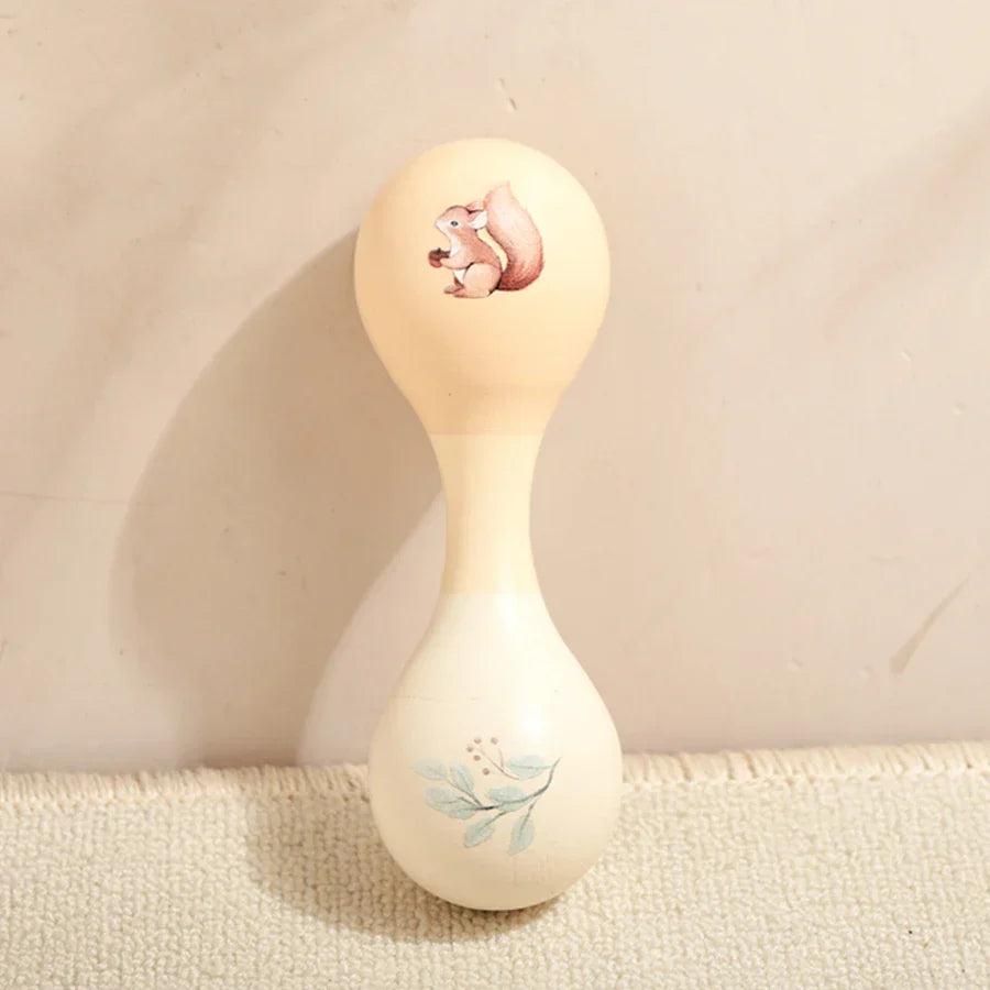 Cream-colored wooden maraca with painted squirrel and leafy branch design for kids wooden montessori percussion instruments
