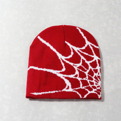 Red knit beanie with white knitting spider web pattern designed as a warm pile cap y2k goth style hat for men and women