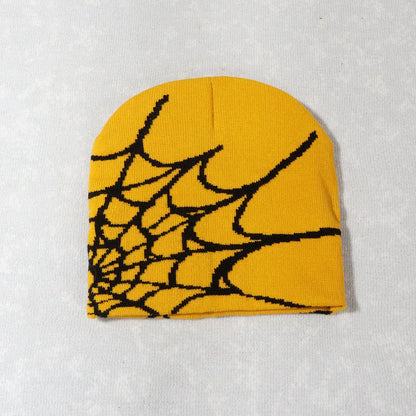 A vibrant yellow knitting spider web pile cap y2k goth beanie for men and women with a bold black pattern