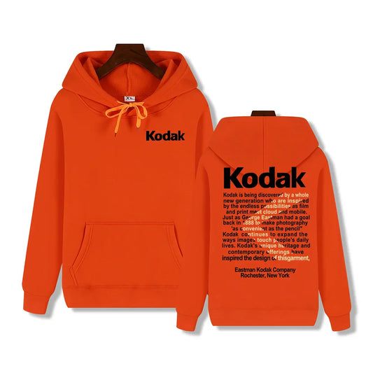 Bright orange kodak hoodie with black branding and printed text block on back retro trend y2k sportswear autumn winter