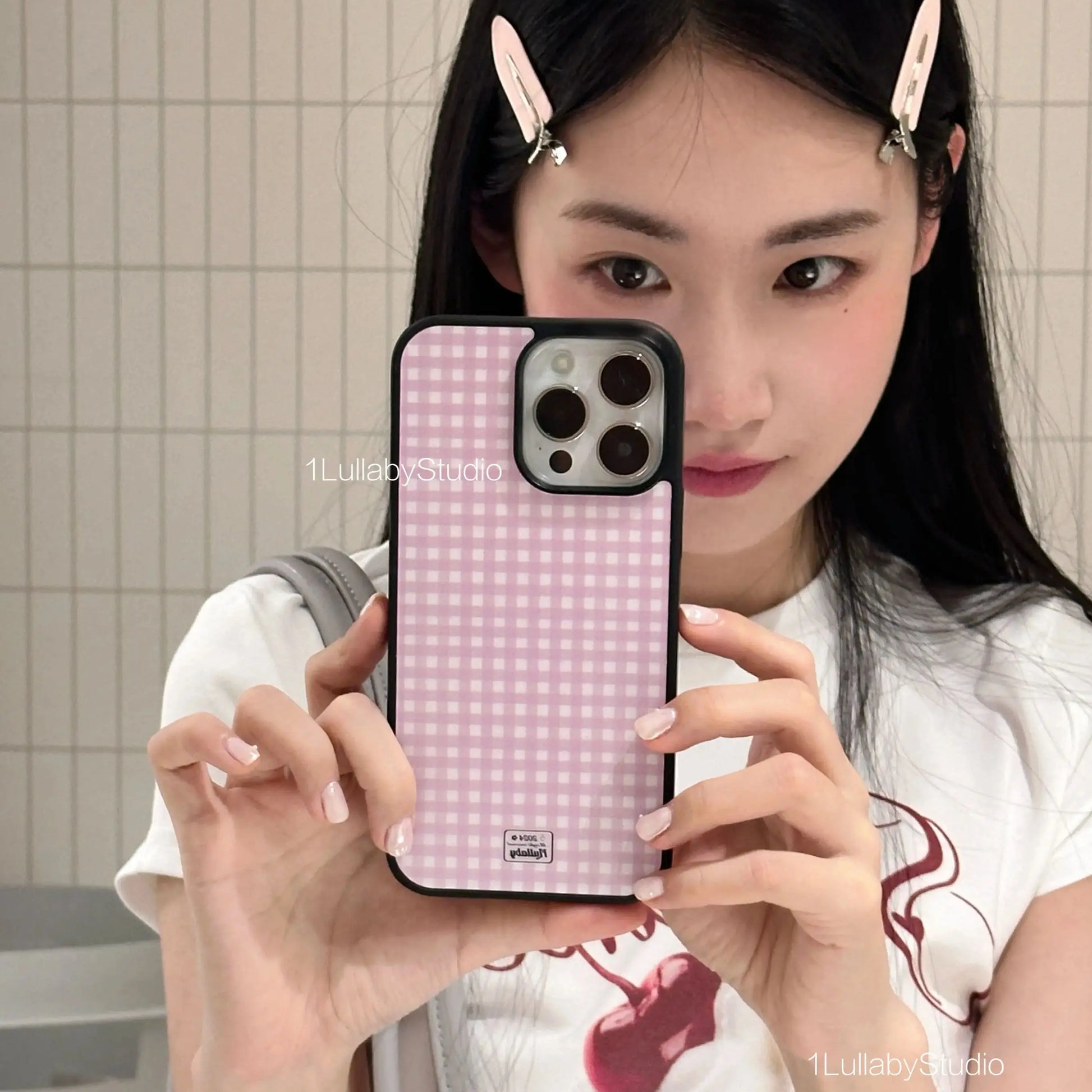 Back view of a korean ins pink gingham plus y2k cover phone case with black border and dot girl heart logo for iphone models