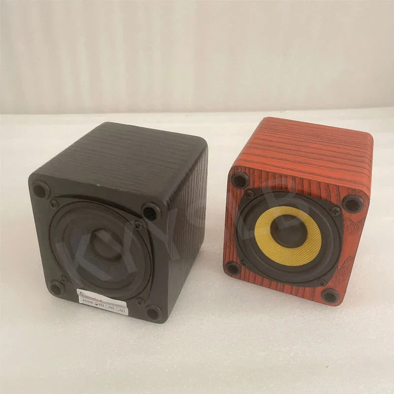 Two cube-shaped 3 inch passive bookshelf speakers with matte black and reddish-brown wood-grain sound amplifier wooden finish