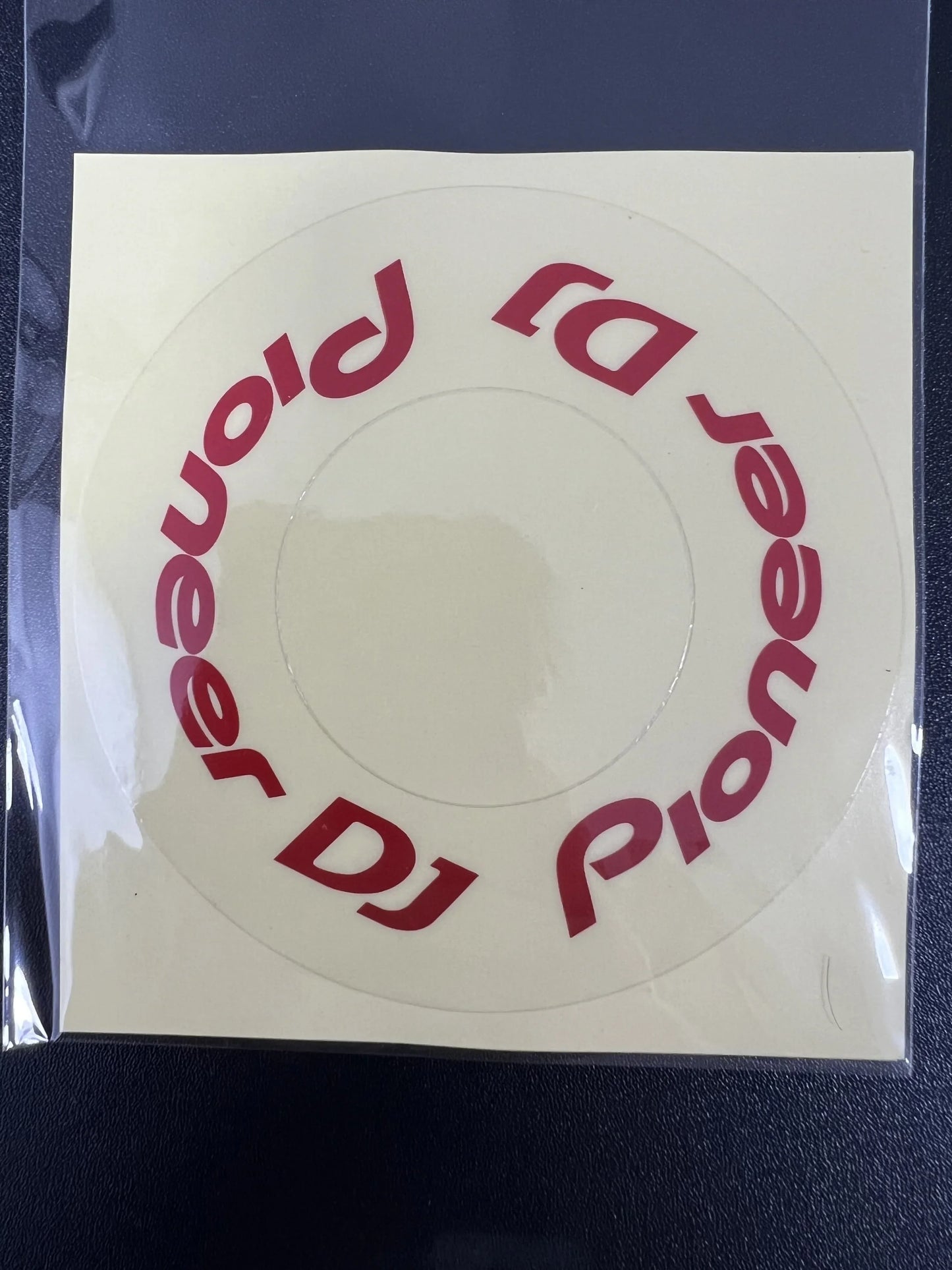 Clear circular sticker with red pioneer dj logo on transparent protective film cdj for large turntable at beat music store