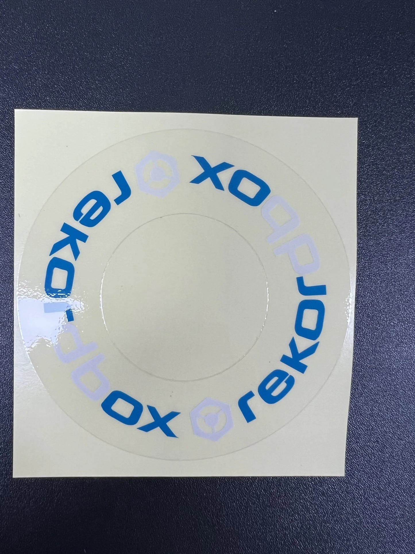 Clear circular sticker with blue xobox text on white backing sheet for large turntable protective film cdj at beat music store