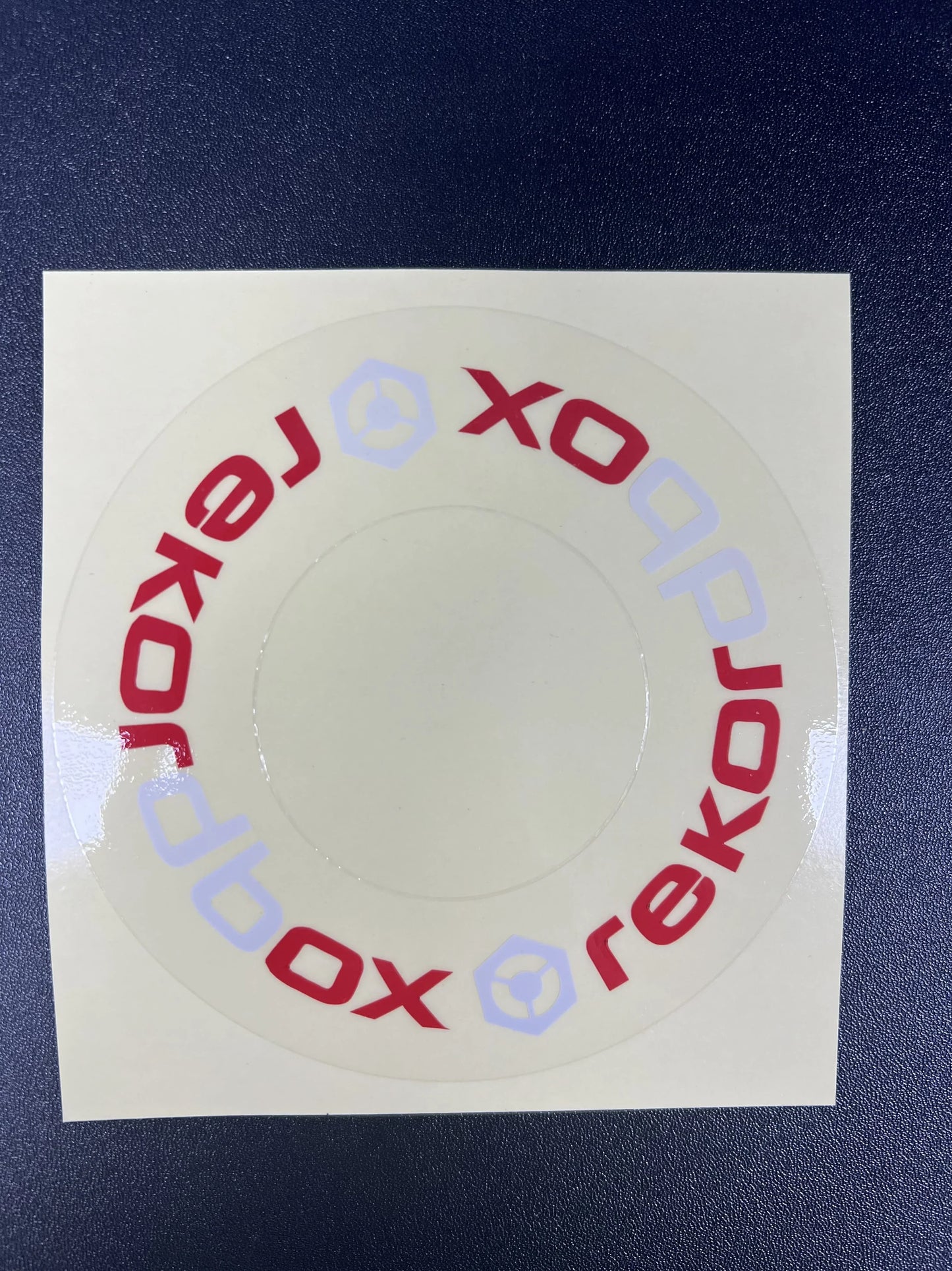 Circular red and light blue xobox branded sticker on clear adhesive backing for large turntable protective film cdj in beat music store