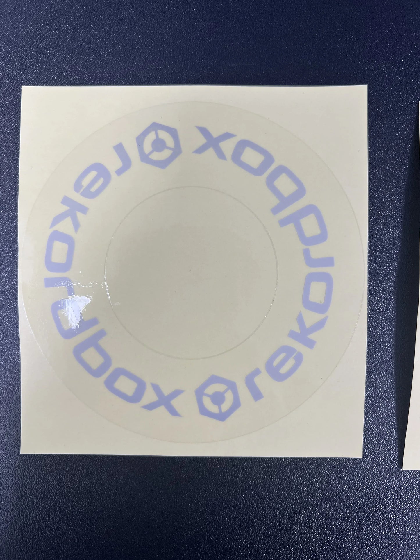 A circular translucent protective film cdj sticker with light purple xobox text for large turntable at beat music store