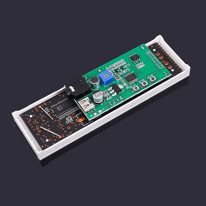 Green and black circuit board inside white casing with usb port capacitors for led audio spectrum car mounted usb device