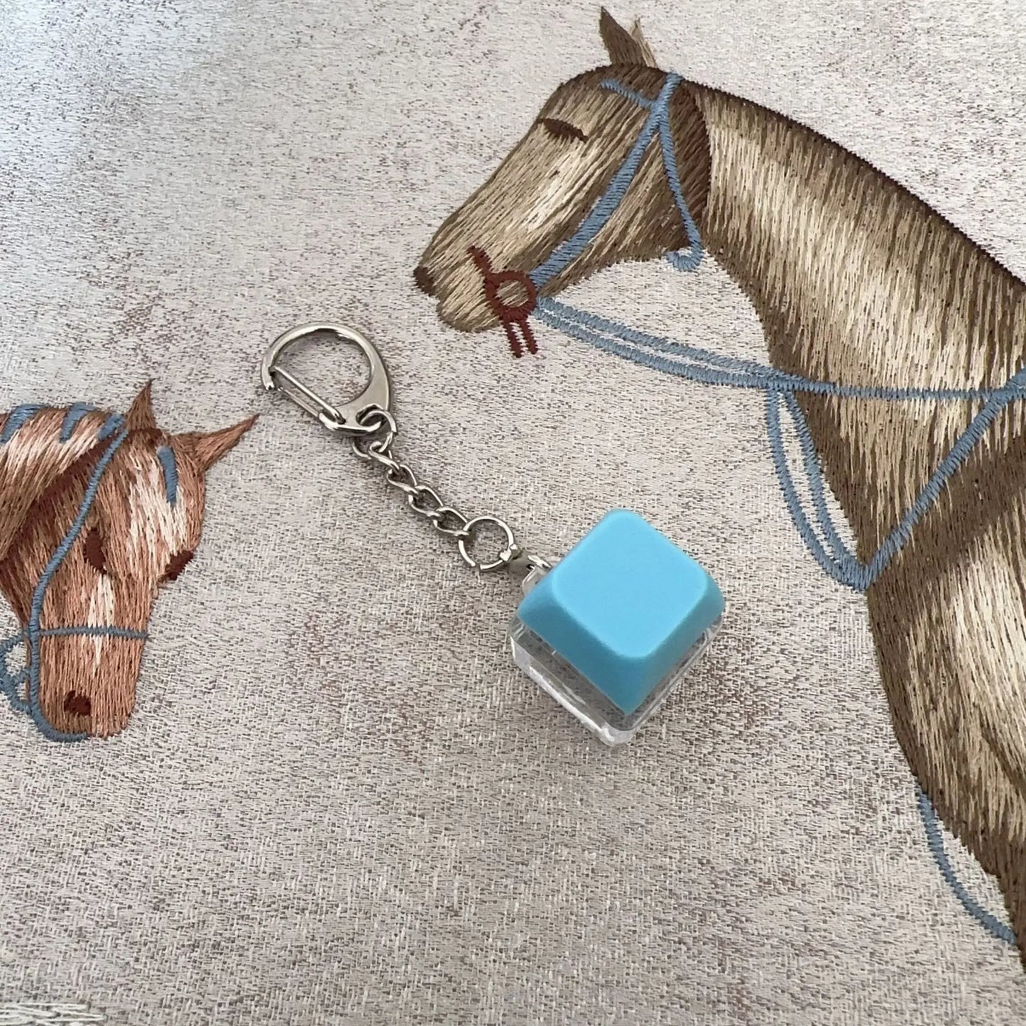 A light blue translucent cube keyboard key chain with a silver metal chain for chain toy stress relief diy button use