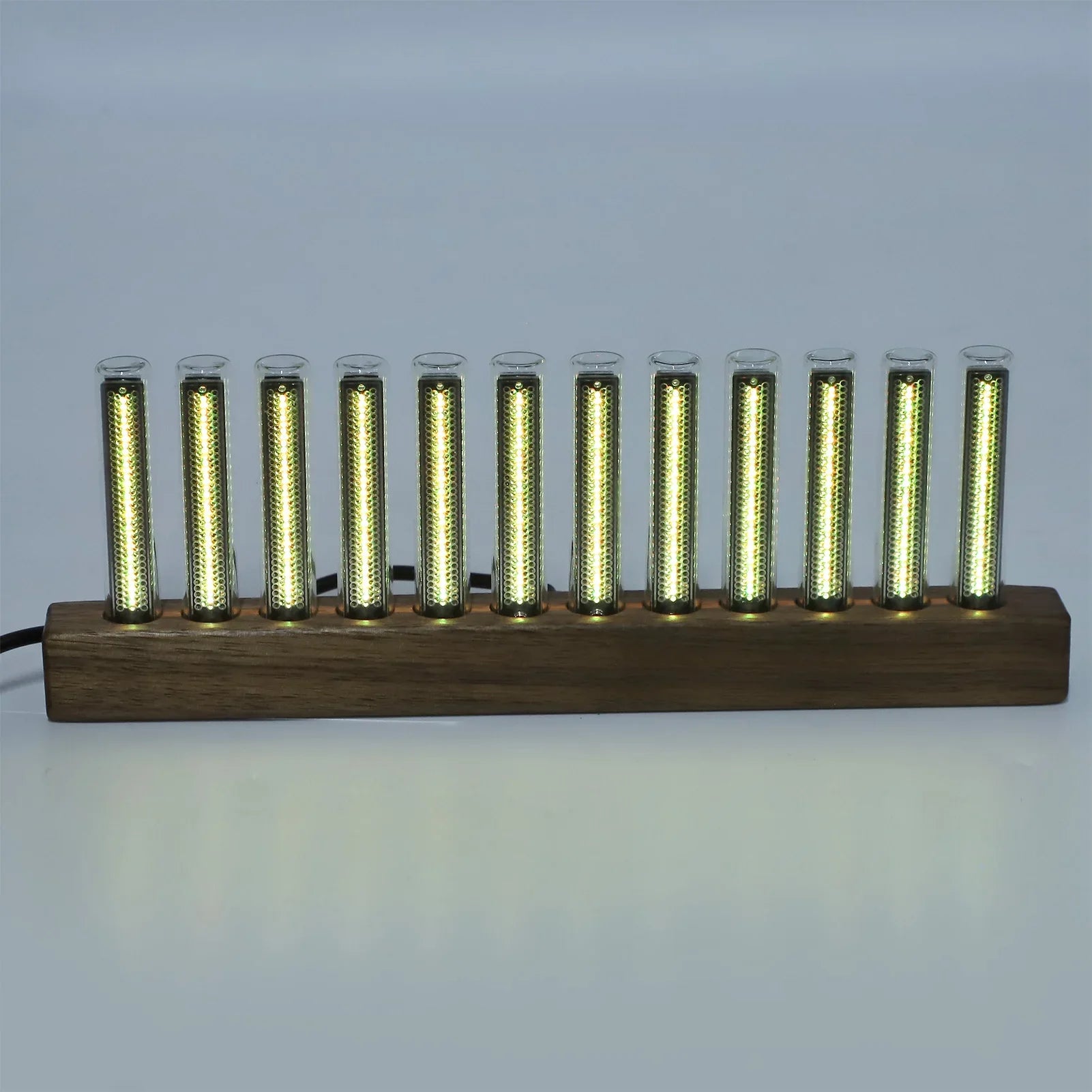 A sleek modern led music spectrum display with ten glowing golden tubes set in a dark wood base for audio analysis