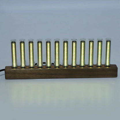 A sleek modern led music spectrum display with ten glowing golden tubes set in a dark wood base for audio analysis