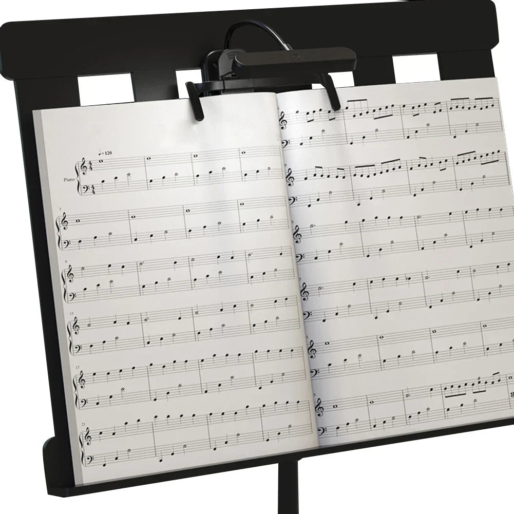 Black metal music stand with rechargeable clip LED music stand light featuring stepless dimming holding piano sheet music