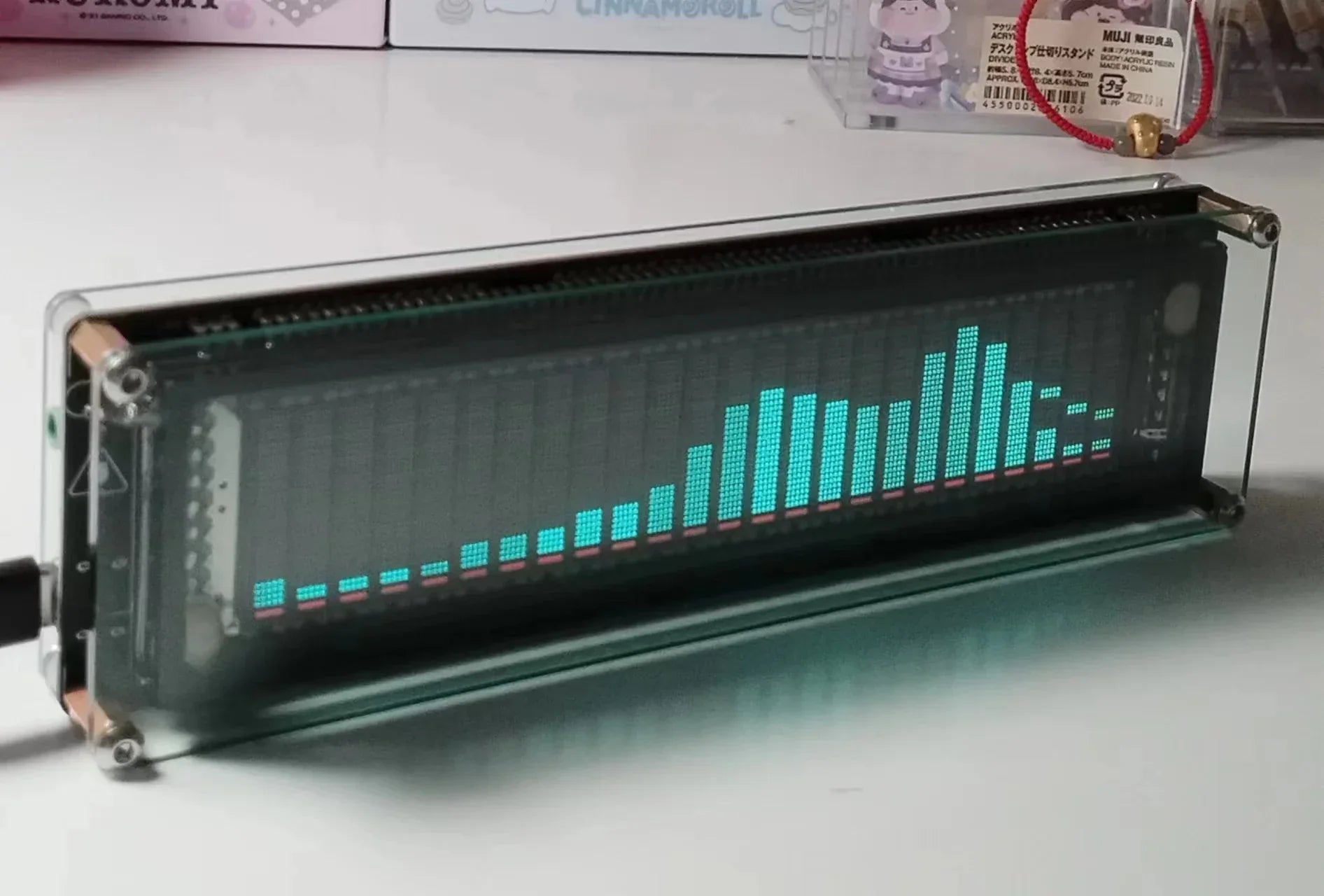 A sleek rectangular link1 ak2515v2vfd music audio spectrum indicator with a black screen and vibrant teal and pink bar graphs