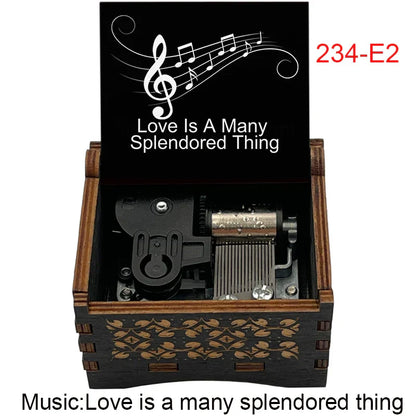 Black wooden music box with engraved floral patterns and lid featuring love is a many splendored thing and musical notes for fans girlfriend couple birthday gift with famous movie melody