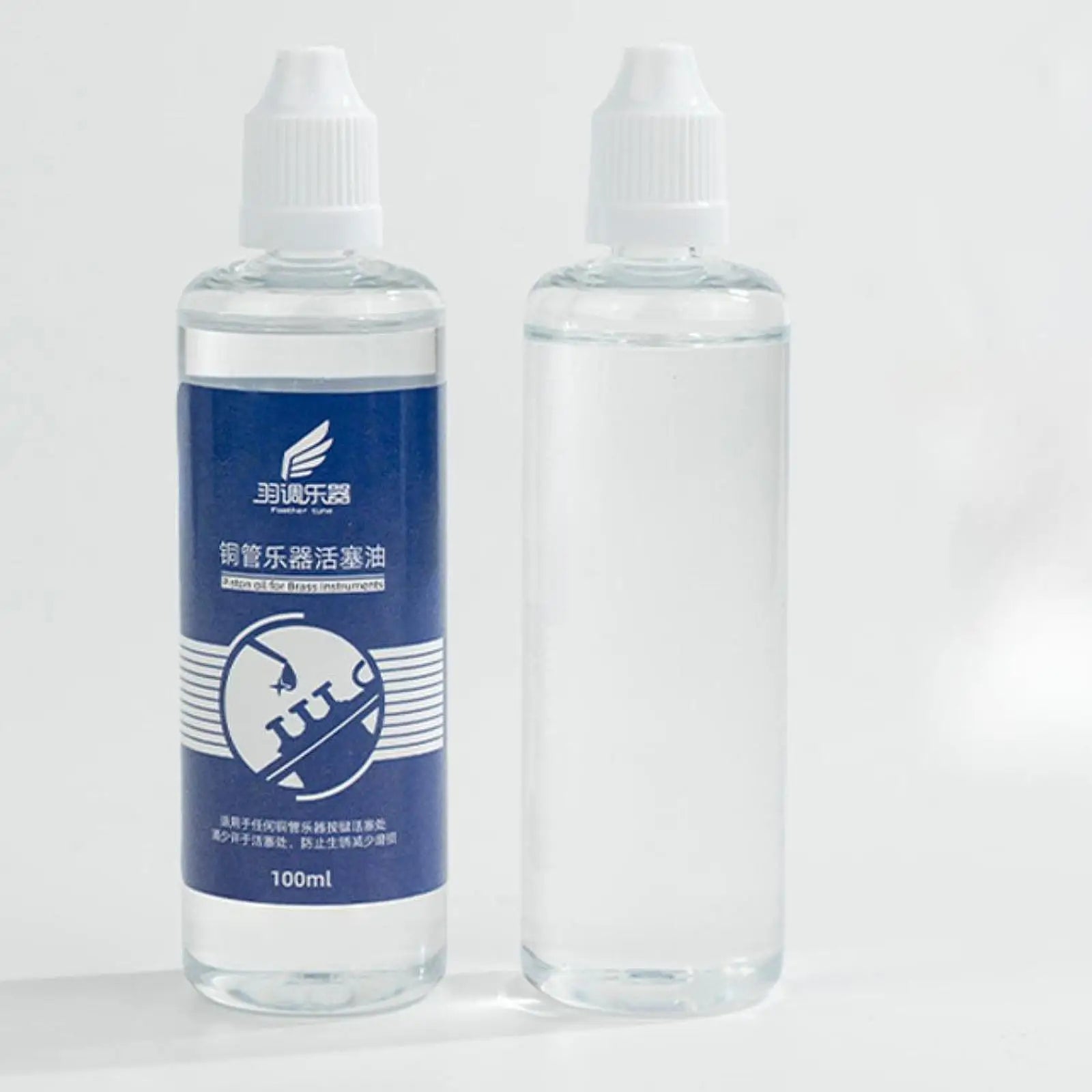 Clear plastic bottle with white cap and blue fender tune label containing valves oil for lubricating oil care and saxophone cleaning