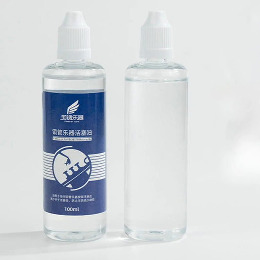 Clear plastic bottle with white cap and blue fender tune label containing valves oil for lubricating oil care and saxophone cleaning