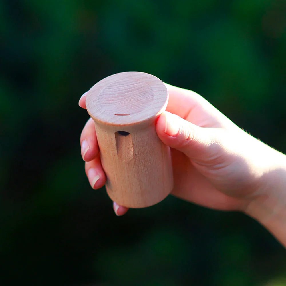A light-colored wooden cylindrical mbat orff musical sound whistle kids educational toy for outdoor and gift use