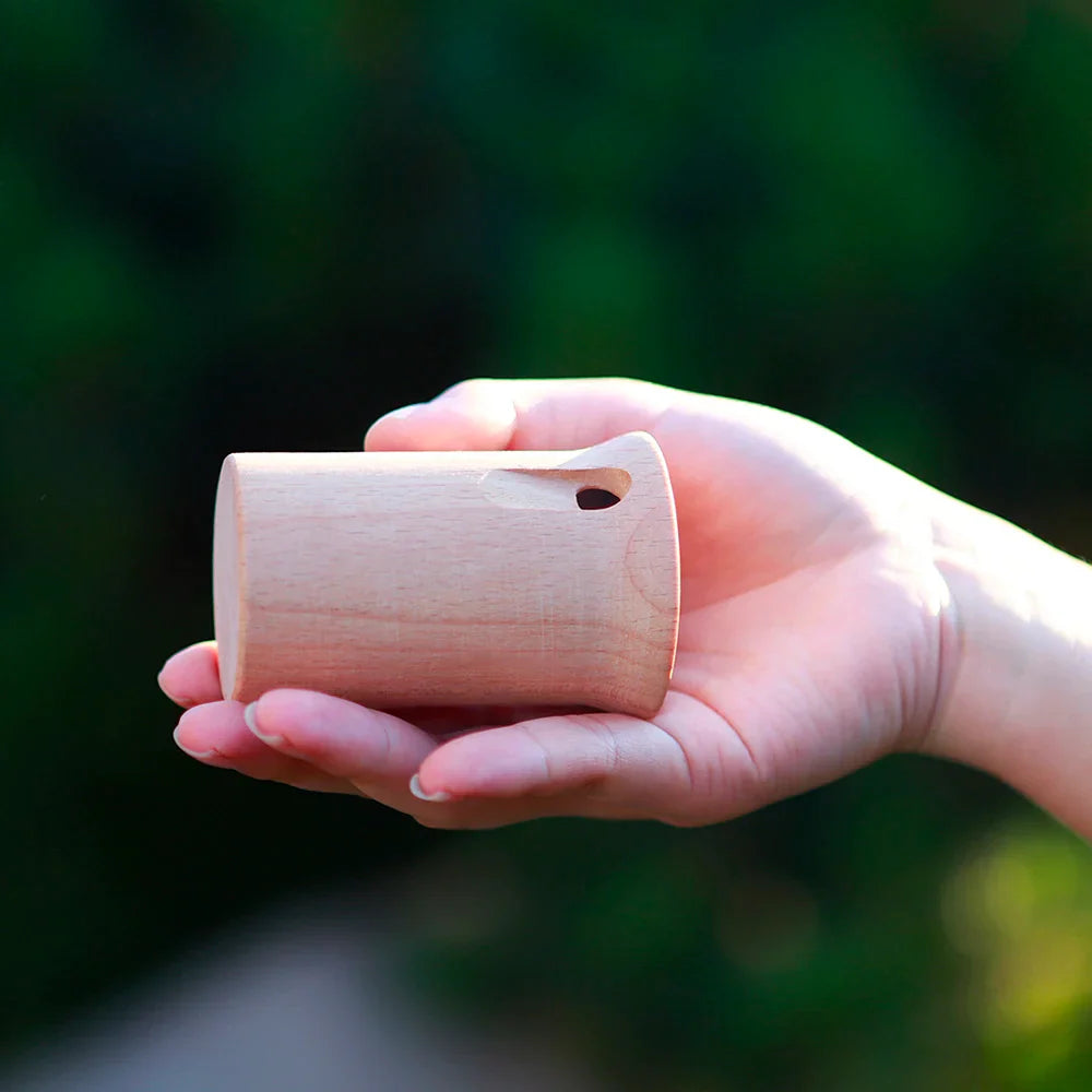 A light-colored wooden cylindrical sound whistle kids educational toy from mbat orff musical for outdoor use