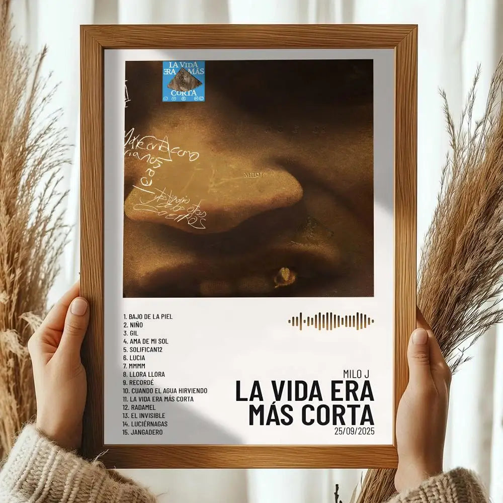 A framed milo j album poster featuring warm brown lips with handwritten signatures in a light wood frame for room wall decals