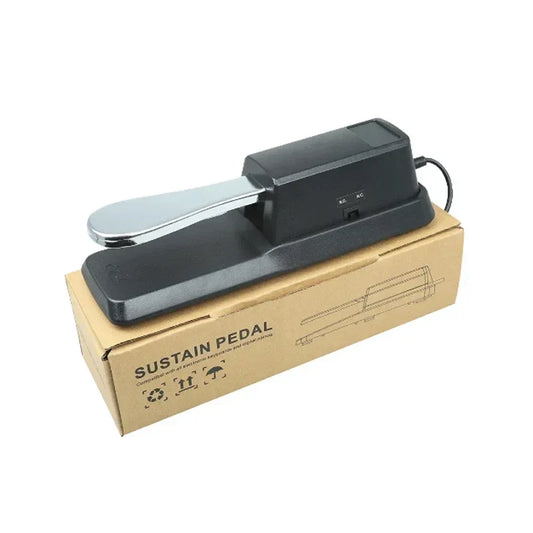 Black sustain pedal with shiny chrome footplate resting on cardboard for m-vave midi mini portable usb keyboard midi controller rechargeable parts