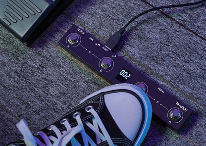 Black m-audio chocolate plus programmable midi controller pedalboard with silver knobs and digital display showing 002