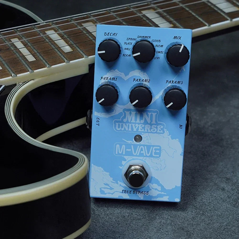 Light blue mini universe digital m-vave guitar effects pedal with black knobs and world map design featuring pedal room shimmer spring reveb effect