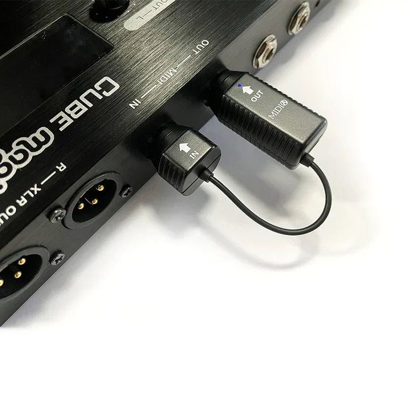 Black ms1 midi adapter with textured surface and labeled in out ports connected to cubase din usb interface midi device connecto