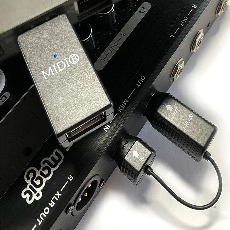 Silver metallic ms1 midi adapter with blue led and midi branding connected to black din usb interface midi device connecto cables