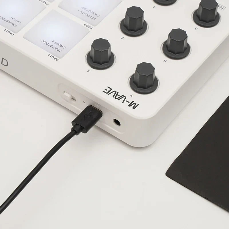 White m-wave midi controller keyboard with black hexagonal strike pads rgb and usb interface pad rgb connection cable