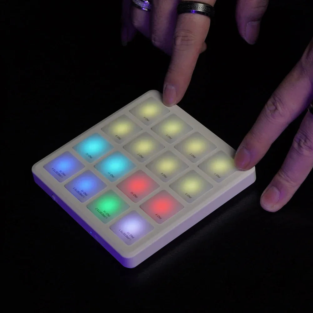 White rectangular midi controller with 16 illuminated color-changing buttons wireless midi controller pocket pad design suitable percussion